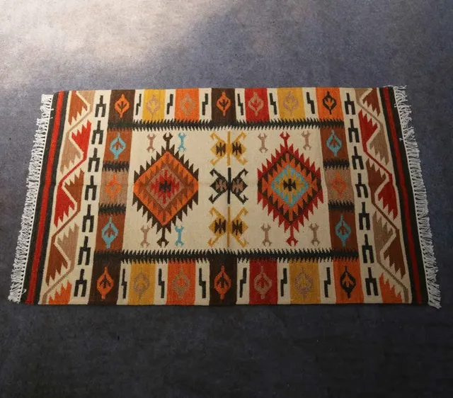 Ochre field — Angular motifs enclosed by a striped geometric border