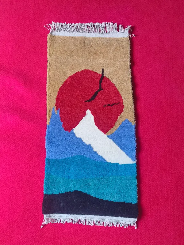 Sun over the peak — A snow peak against a red sun