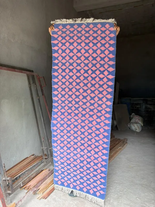 Rose lattice — A repeating pink lattice across a deep blue field