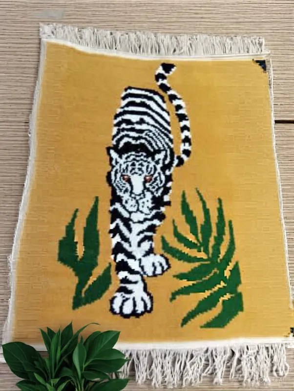 Tiger among the leaves — A striped tiger framed by green leaves